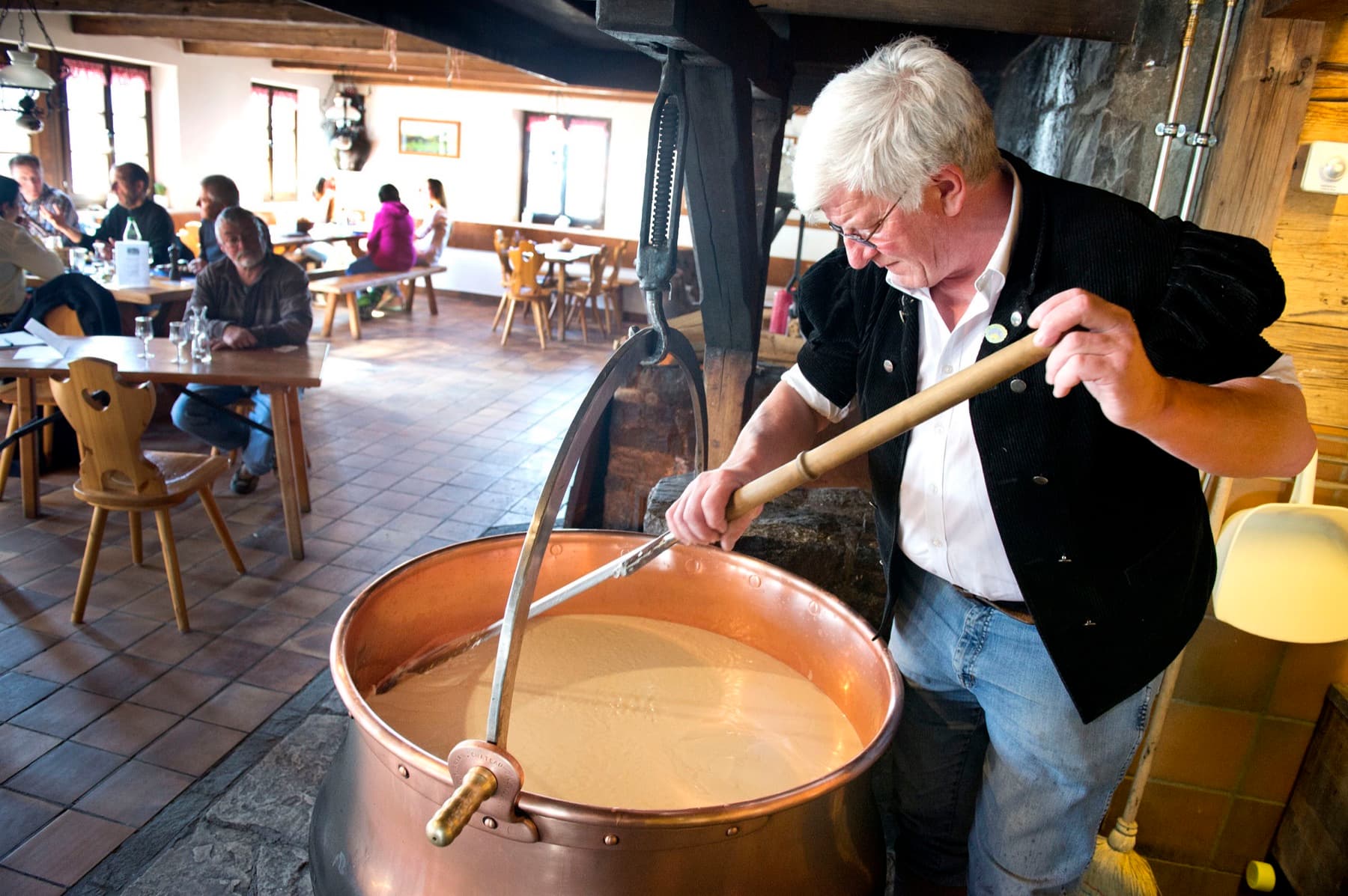 Stirring success of Le Chalet’s customary cheese production. Photograph: Gérald Bosshard, Switzerland Tourism
